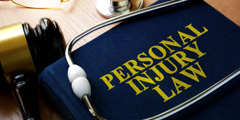 Personal Injury Law concept. Book and stethoscope.